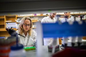 Postdoc Esther Broset, postdoc Marcelo Torres, and Presidential Professor Cesar de la Fuente in the lab in November 2019. The work of this team sits at the intersection of computer science and microbiology. Since the lab temporarily closed, the researchers have moved their computational efforts completely offsite, save for those deemed “essential personnel,” who come to campus occasionally to check on key equipment.