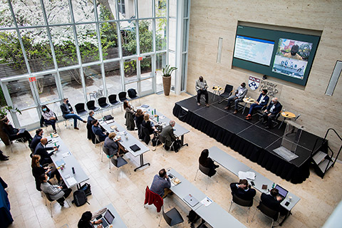Aerial view of a panel and audience at an event at Perry World House